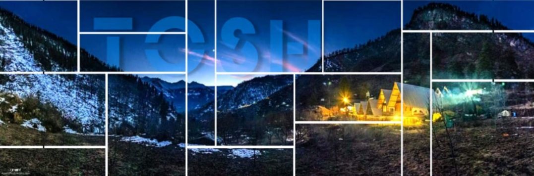 Terraced mountain village of Tosh at dusk with snow peaks in the background